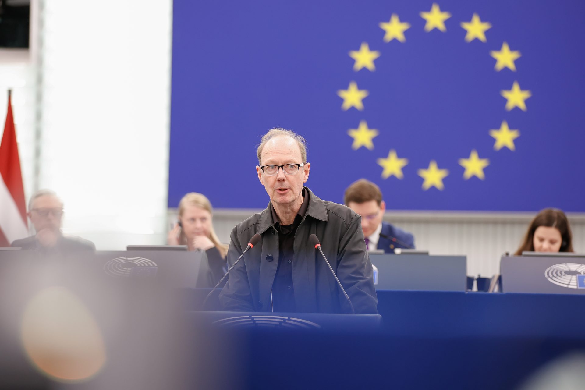 Martin Sonneborn am Rednerpult des Europäischen Parlaments, im Hintergrund die EU-Flagge.